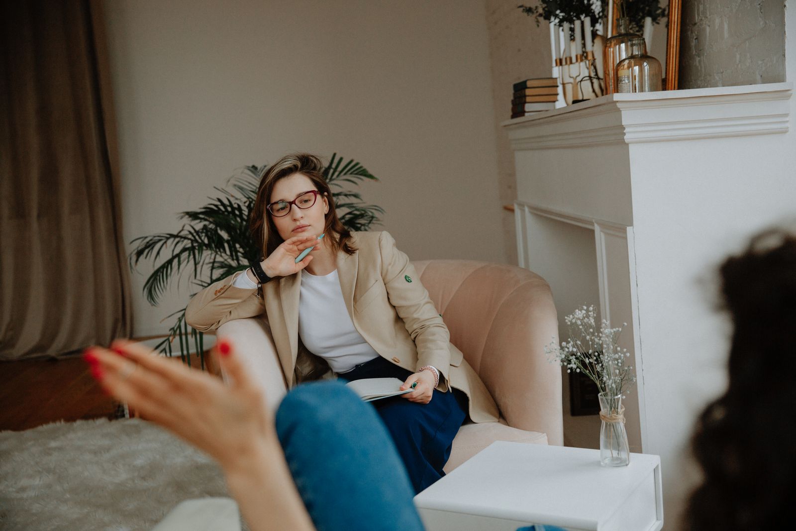 A psychologist listening in a calm consulting room